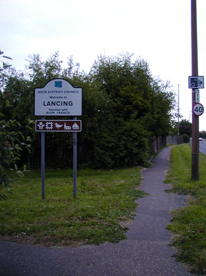 The original Adur sign welcoming you to Lancing correctly placed at the Lancing border.